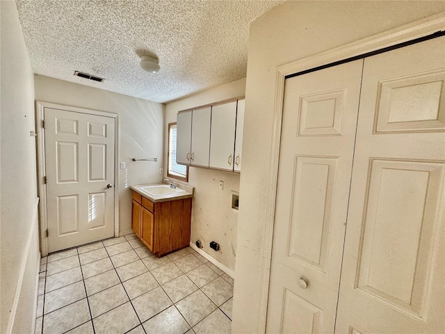 bathroom featuring tile patterned flooring, vanity, and a textured ceiling