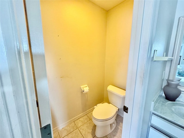 bathroom featuring tile patterned flooring, vanity, and toilet