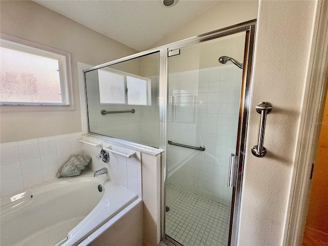 bathroom featuring independent shower and bath and lofted ceiling