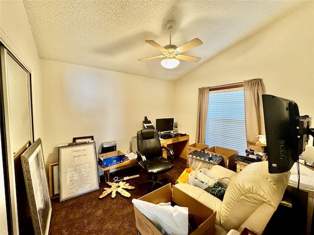 carpeted home office featuring a textured ceiling, ceiling fan, and lofted ceiling