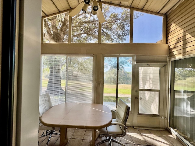 sunroom / solarium with ceiling fan, lofted ceiling, and a wealth of natural light