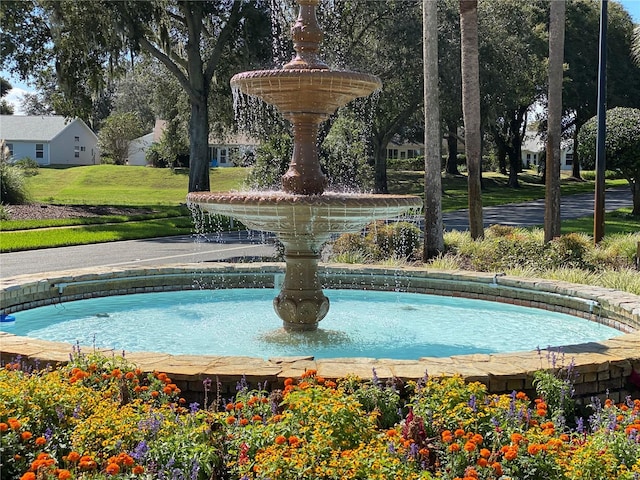 view of pool with a yard