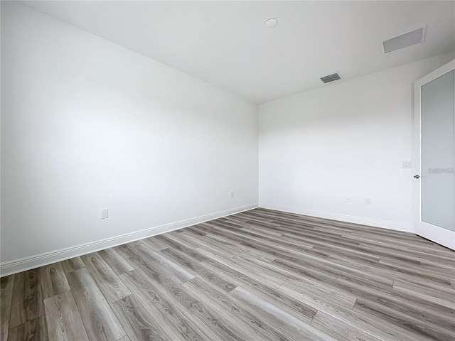 unfurnished room with light hardwood / wood-style floors