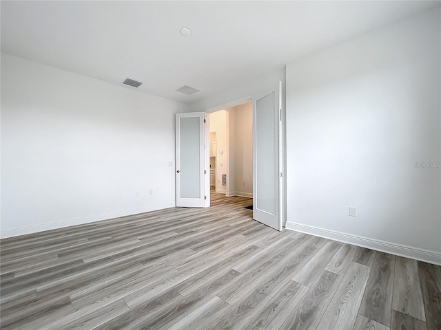 spare room featuring light wood-type flooring