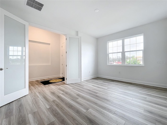 unfurnished room featuring light hardwood / wood-style flooring