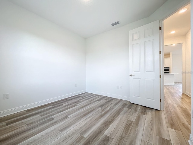 empty room with light wood-type flooring