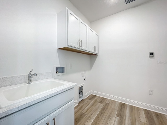 washroom featuring sink, cabinets, electric dryer hookup, hookup for a washing machine, and light hardwood / wood-style floors