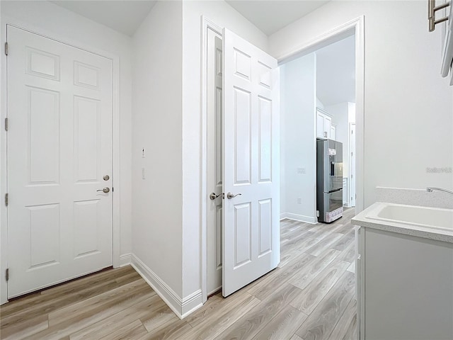 hallway featuring light hardwood / wood-style floors and sink