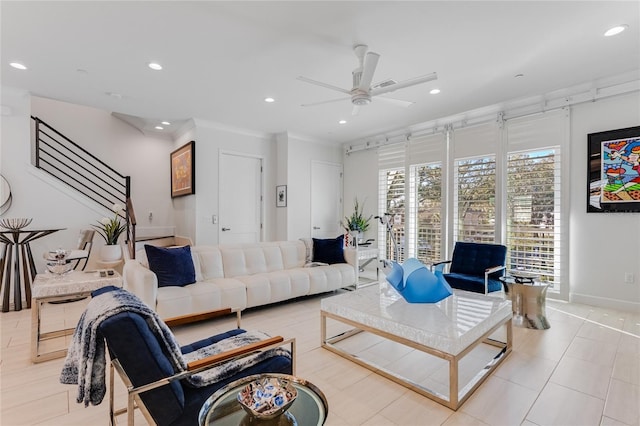 living room featuring ceiling fan and ornamental molding