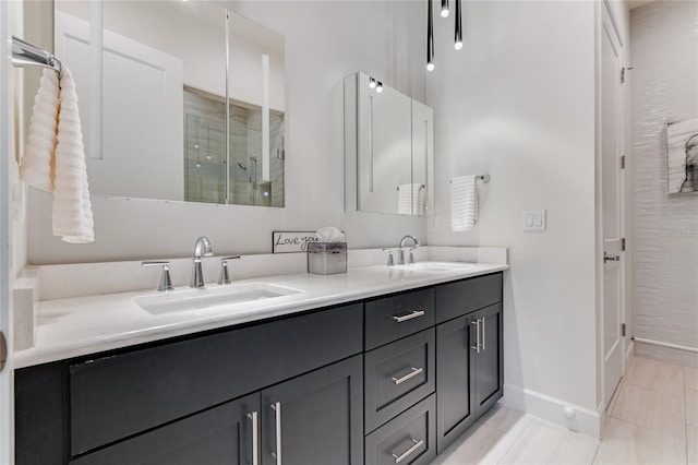 bathroom with tile patterned floors, an enclosed shower, and vanity