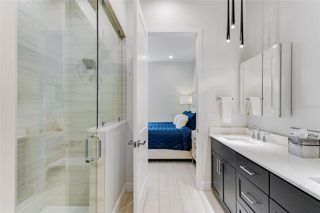 bathroom with a shower with door and vanity