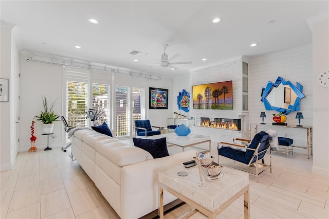 living room with a fireplace and ceiling fan