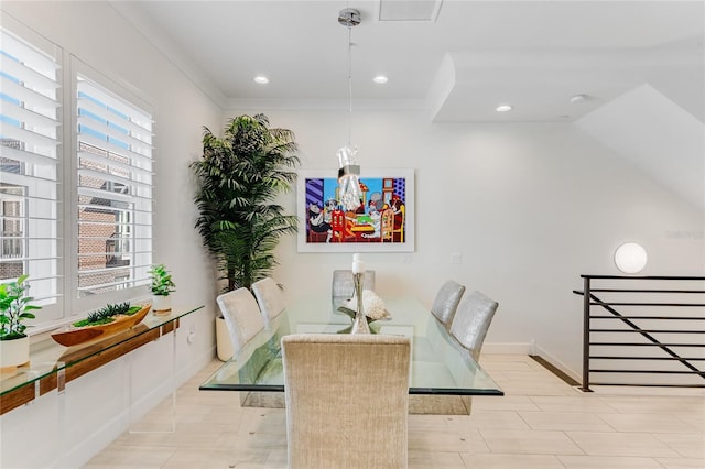 dining area featuring lofted ceiling and ornamental molding