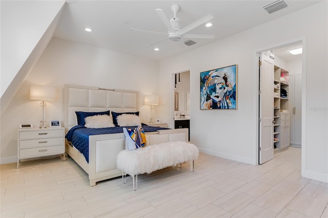 bedroom featuring ceiling fan, a spacious closet, a closet, and ensuite bath