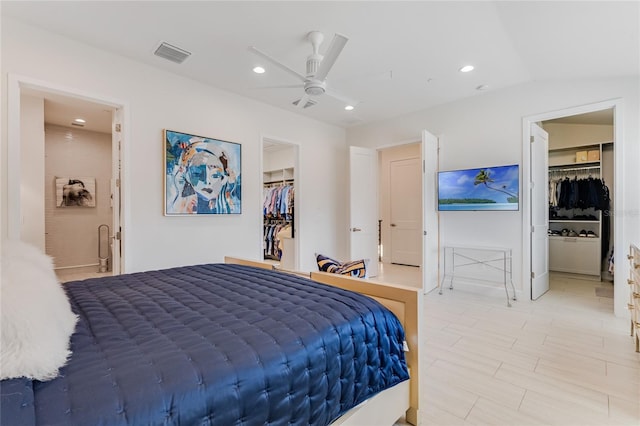 bedroom featuring lofted ceiling, connected bathroom, a spacious closet, a closet, and ceiling fan