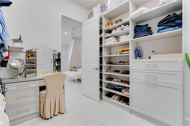 spacious closet with light tile patterned floors