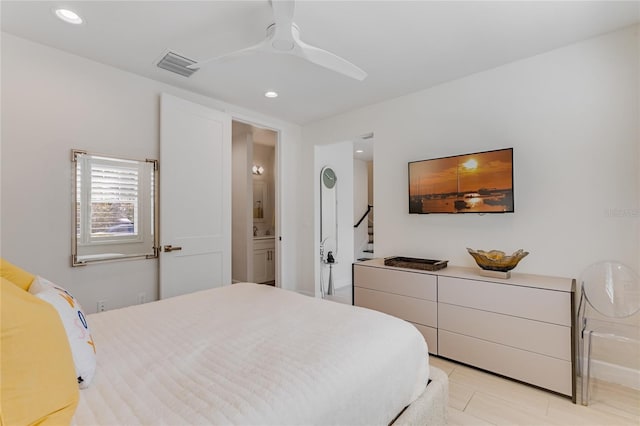 tiled bedroom with ensuite bath and ceiling fan