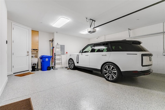 garage with a garage door opener and electric panel