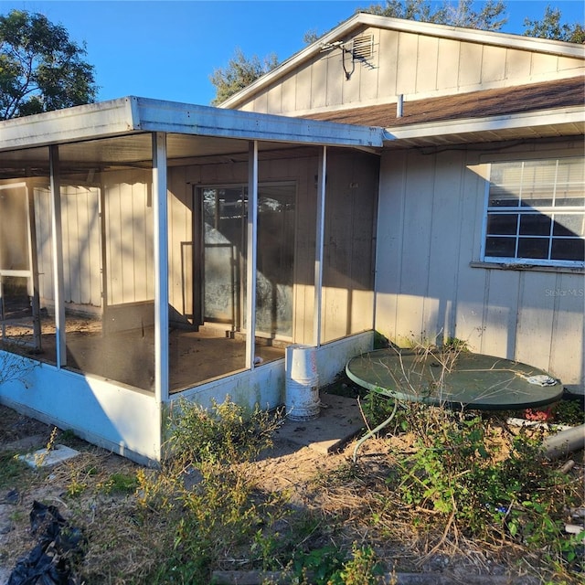 view of property exterior with a sunroom