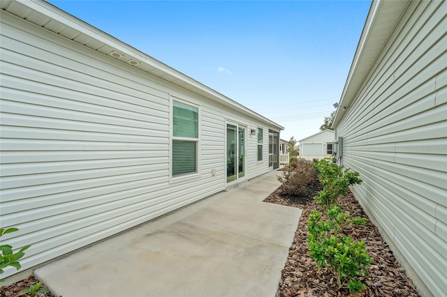 view of side of home featuring a patio area