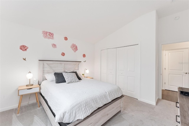 bedroom with light carpet, a closet, and lofted ceiling