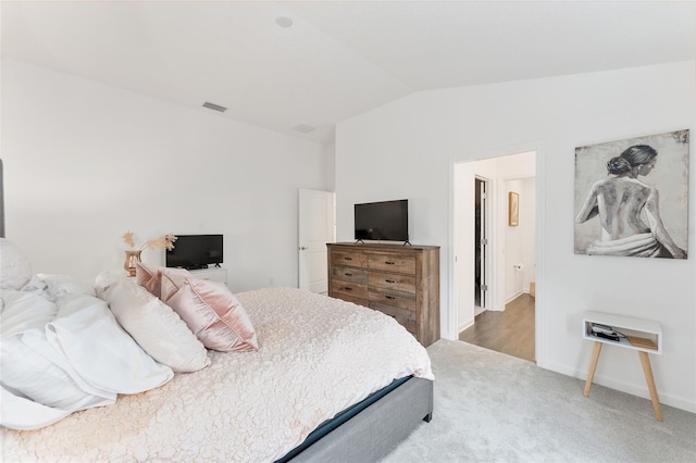 carpeted bedroom featuring vaulted ceiling