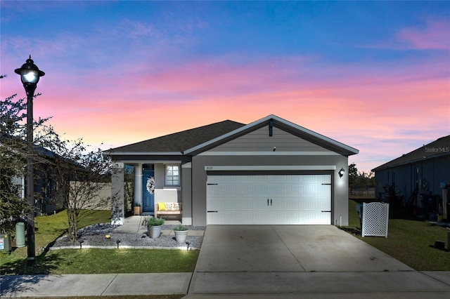 view of front facade with a lawn and a garage