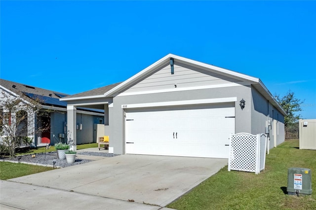 view of front of property with a garage and a front lawn