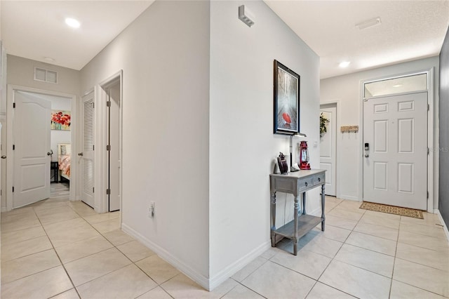 foyer featuring light tile patterned floors