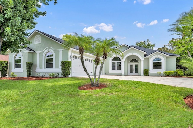 11941 Graces Way, Clermont, FL 34711 - ranch-style house with french doors, stucco siding, driveway, and an attached garage