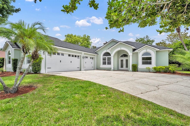 11941 Graces Way, Clermont, FL 34711 - ranch-style house with an attached garage, driveway, french doors, a front lawn, and stucco siding