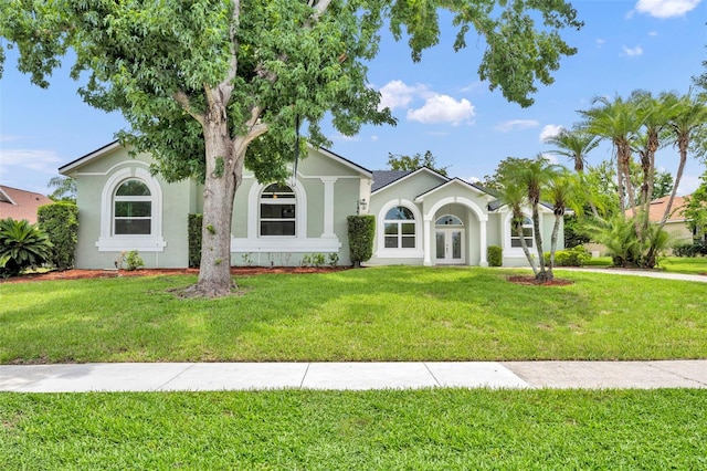 11941 Graces Way, Clermont, FL 34711 - view of front facade featuring french doors, stucco siding, and a front yard