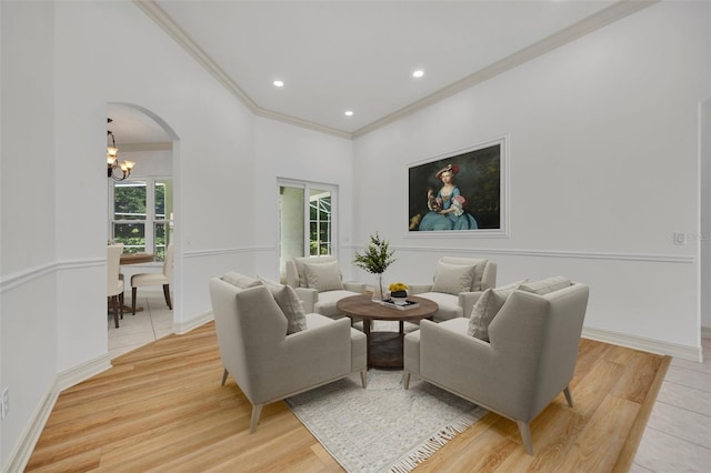 11941 Graces Way, Clermont, FL 34711 - living room with ornamental molding, a chandelier, arched walkways, light wood-style floors, and recessed lighting