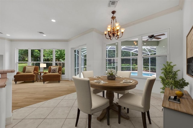 11941 Graces Way, Clermont, FL 34711 - dining area with ornamental molding, light tile patterned flooring, a chandelier, ceiling fan, and recessed lighting