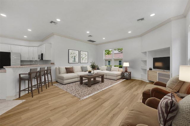 11941 Graces Way, Clermont, FL 34711 - living room featuring crown molding, recessed lighting, and light wood-style flooring