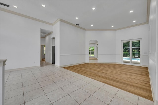 11941 Graces Way, Clermont, FL 34711 - unfurnished room with arched walkways, light tile patterned flooring, ornamental molding, and recessed lighting
