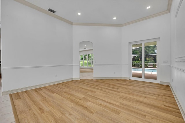 11941 Graces Way, Clermont, FL 34711 - empty room featuring arched walkways, ornamental molding, light wood finished floors, and recessed lighting
