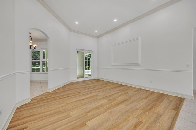 11941 Graces Way, Clermont, FL 34711 - spare room with ornamental molding, a chandelier, light wood-style floors, arched walkways, and recessed lighting
