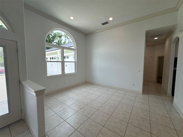 11941 Graces Way, Clermont, FL 34711 - unfurnished room with light tile patterned floors, crown molding, arched walkways, recessed lighting, and a textured ceiling