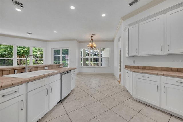 11941 Graces Way, Clermont, FL 34711 - kitchen with dishwashing machine, a chandelier, white cabinetry, ornamental molding, and light tile patterned flooring