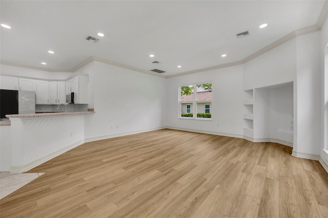 11941 Graces Way, Clermont, FL 34711 - unfurnished living room featuring crown molding, light wood-type flooring, and recessed lighting