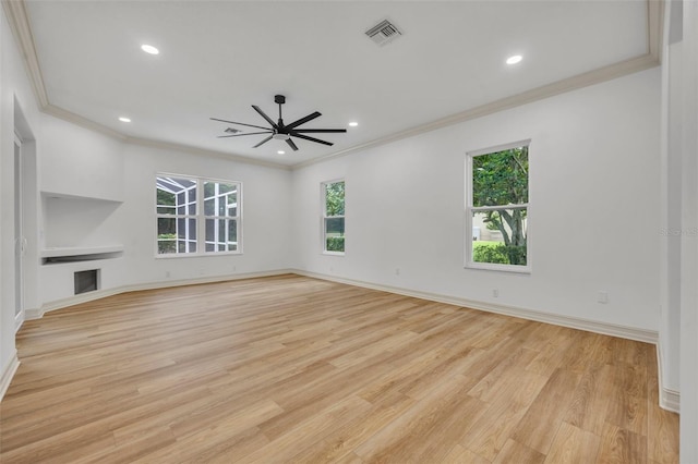 11941 Graces Way, Clermont, FL 34711 - unfurnished living room with ornamental molding, light wood finished floors, recessed lighting, and a fireplace