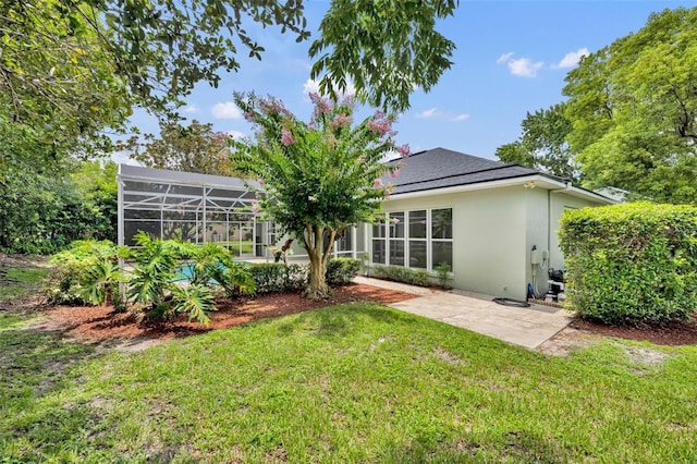 11941 Graces Way, Clermont, FL 34711 - back of property featuring stucco siding, a lawn, a patio, and a lanai
