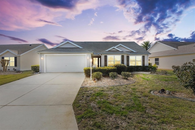 ranch-style home featuring a yard and a garage