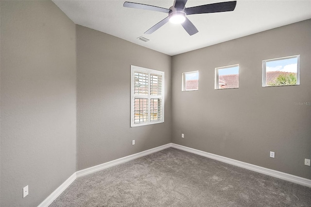 carpeted empty room featuring ceiling fan