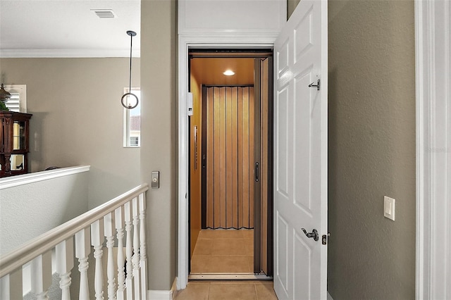 hall with crown molding, elevator, and light tile patterned floors