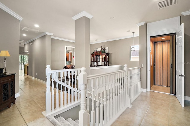 corridor featuring ornamental molding and light tile patterned floors