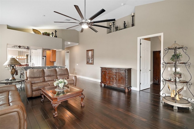 living room with ceiling fan, dark wood-type flooring, and high vaulted ceiling