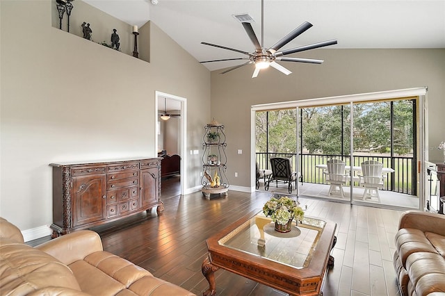 living room featuring ceiling fan, dark hardwood / wood-style flooring, and vaulted ceiling