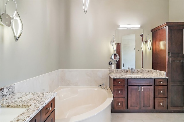 bathroom with a bath, tile patterned floors, and vanity